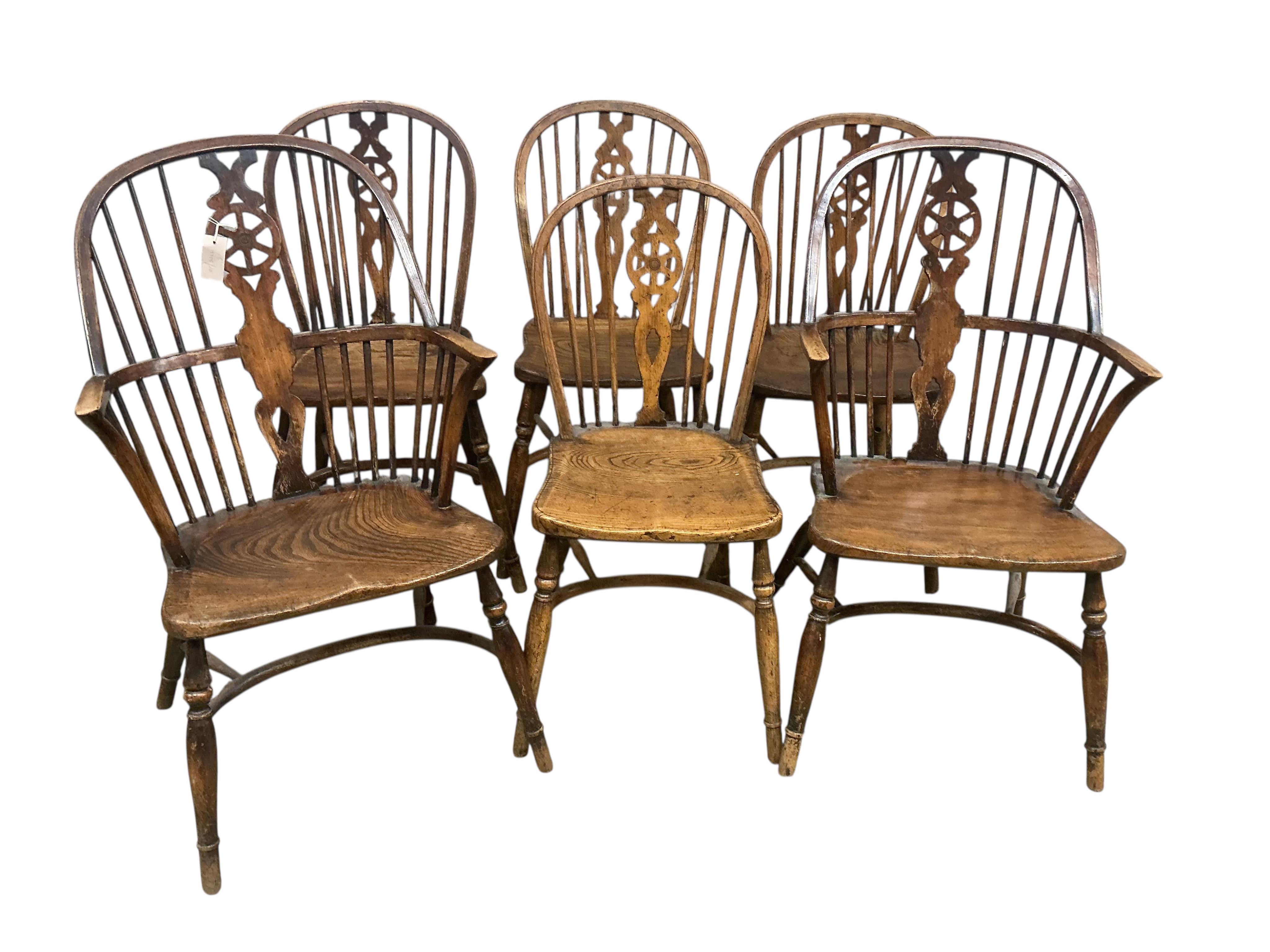 A set of six 20th century elm and beech Windsor chairs with pierced splats and crinoline stretchers, two with arms